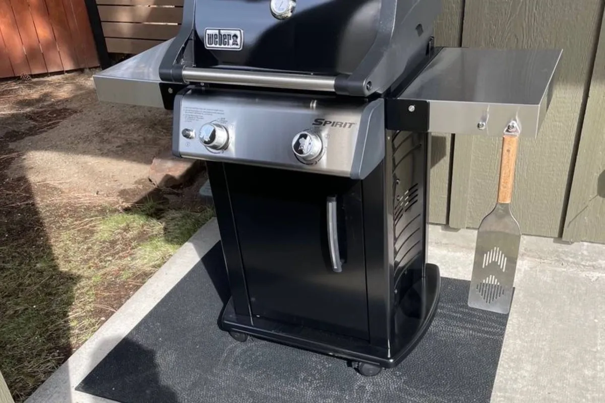 A cheerful outdoor grilling station set up on the deck, complete with a barbecue grill and utensils, ready for gatherings and creating memorable meals.